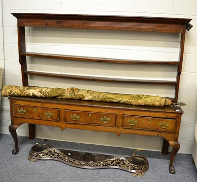 Lot 1488 - A George III oak dresser, the rack having a moulded cornice and pierced frieze over three...