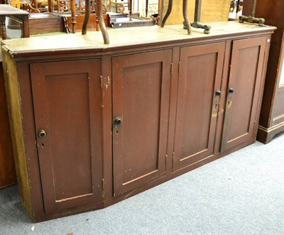 Lot 1503 - ~ A painted pine four door cupboard and two towel rails