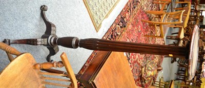 Lot 1520 - ^ A carved mahogany torchere on three cabriole legs