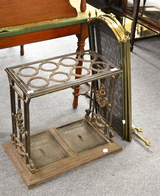 Lot 1526 - ~ A Victorian cast iron stick stand with drip trays, a spark guard, fire tongs, shovel and poker