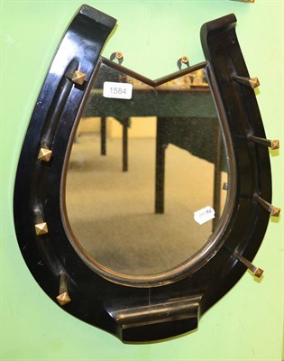 Lot 1584 - An ebony horseshoe mirror