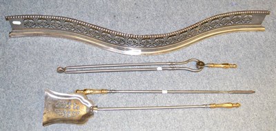 Lot 1586 - A pierced steel fender of serpentine shape and set of three fire irons