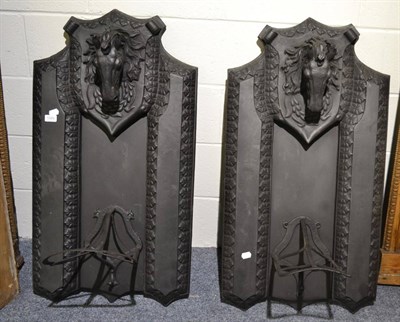 Lot 1589 - A pair of cast iron saddle racks surmounted by horse`s heads