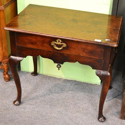 Lot 1613 - An 18th century oak low boy on cabriole legs and pad feet