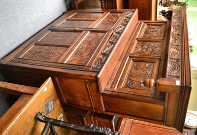 Lot 1630 - A joined and carved oak press cupboard, with a moulded cornice and lunette frieze over a...