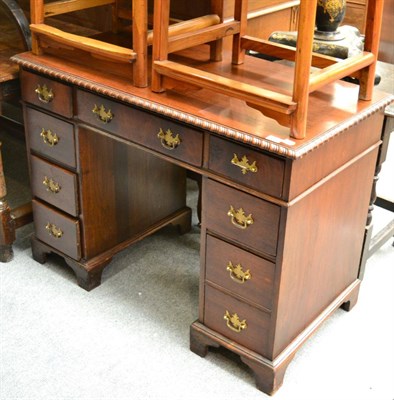 Lot 1633 - A carved mahogany straight fronted pedestal desk