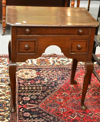 Lot 1656 - A George III oak lowboy