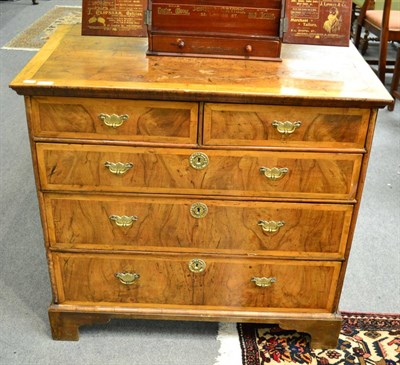 Lot 1658 - An 18th century walnut and pearwood banded chest of drawers, with a moulded top over two short...