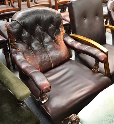 Lot 1675 - ~ A late Victorian armchair upholstered in close nailed leather with later covered seat