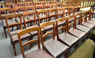 Lot 1677 - ~ Thirty-five Victorian walnut dining chairs upholstered with brown close nailed leather seats...