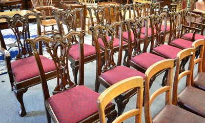 Lot 1678 - A set of reproduction dining chairs in the Chippendale style with drop in seats, including two...