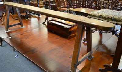 Lot 1693 - A 19th century fruitwood form bench with triangular end supports