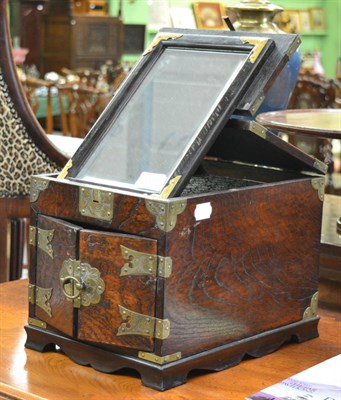 Lot 1695 - A Chinese style elm brass bound jewellery box, the cover opening to reveal an easel mirror and...