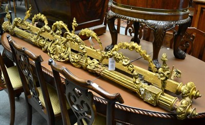 Lot 1708 - A pair of 19th century gilt and gesso curtain poles decorated with floral swags