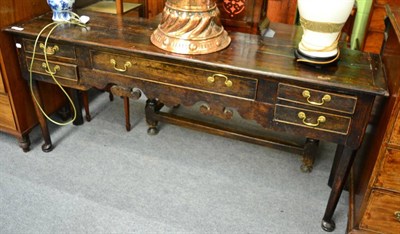 Lot 1738 - An oak low dresser, with a moulded top and five drawers to the shaped apron, on turned legs...