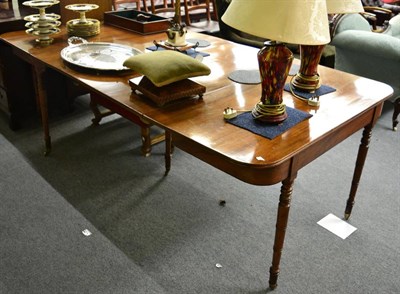 Lot 1740 - A Regency mahogany dining table, comprising two D-ends on slender turned legs and castors, each...