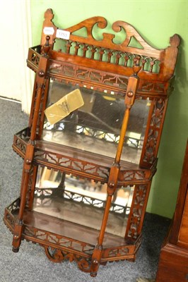 Lot 1753 - * A set of late Victorian walnut hanging shelves, with mirror backs and elegant spindle supports