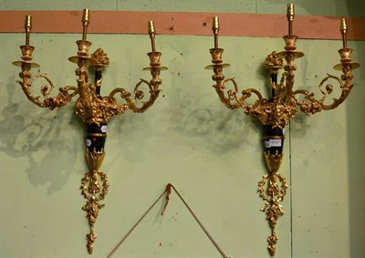 Lot 1757 - A pair of gilt-bronze three branch wall lights