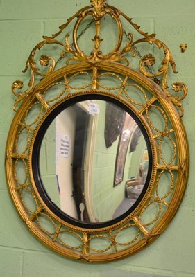 Lot 1759 - * A 19th century gilt and gesso circular wall mirror, with ebonised slip