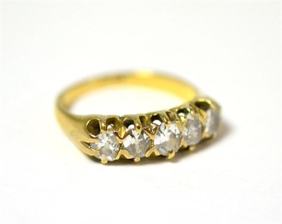 Lot 23 - A diamond five stone ring, the graduated old cut diamonds in yellow claws, on a plain polished...