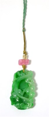 Lot 41 - A carved jade pendant, depicting fruiting vines, strung with a pink stone and seed pearls, on a...