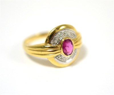 Lot 47 - A ruby and diamond ring, an oval cut ruby in a yellow rubbed over setting, to a part diamond...
