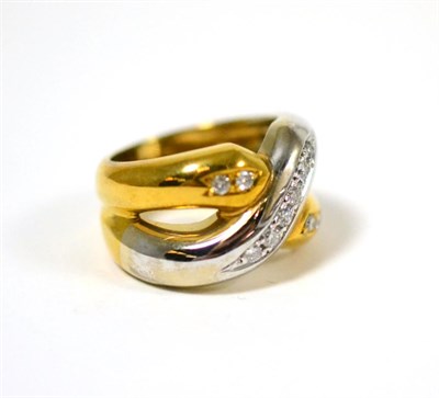 Lot 49 - A diamond set ring, the cross-over design in yellow and white, set with round brilliant cut...