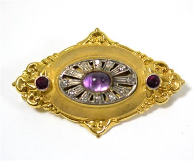 Lot 54 - An amethyst brooch, of lozenge form, with matt finish and polished scroll decoration, a...