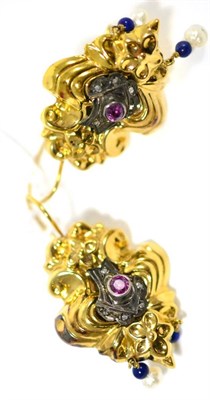 Lot 62 - A pair of drop earrings, with floral decoration, inset with a ruby and rose cut diamonds, two lapis