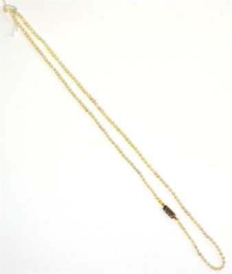 Lot 64 - A pearl necklace, the graduated pearls knotted to an oblong catch set with three rose cut diamonds