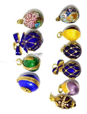 Lot 94 - Nine egg charms and an ball, enamelled in assorted colours, some hinged to open