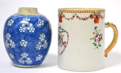 Lot 125 - ^A Chinese export porcelain mug, painted in European style with a floral shield, 13.5cm high; and a