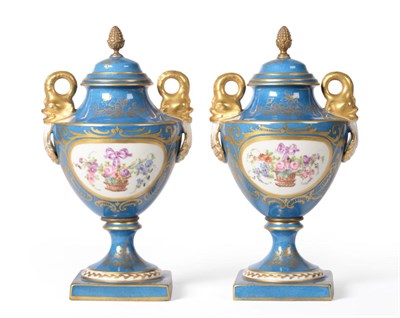 Lot 128 - A pair of Paris powder blue ground vases and cover, circa 1900, painted with baskets of...
