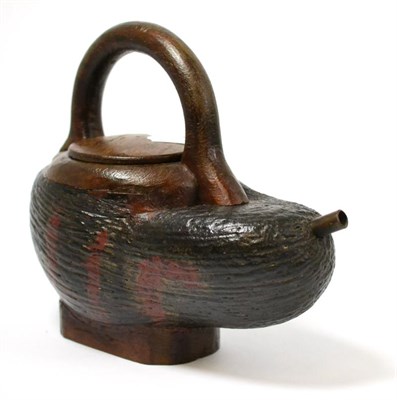 Lot 137 - Coco de mer nut half nut drinking vessel, with applied handle, foot, and copper spout 24cm by 22cm