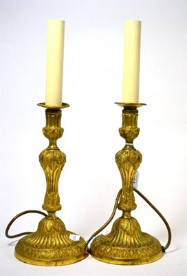 Lot 161 - A pair of late 18th century Continental ormolu candlesticks, converted to lamps, 28cm high