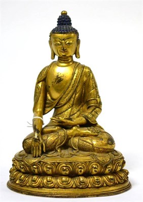 Lot 162 - A South East Asian gilt bronze figure of Buddha, seated on a lotus base, 19cm high