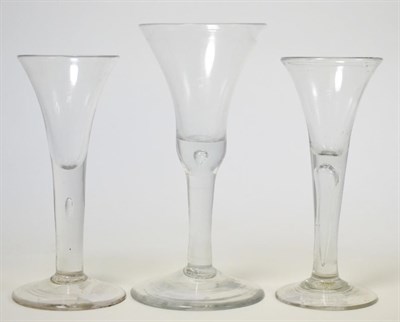 Lot 171 - A group of three 18th century English wine glasses, with trumpet bowls on air twist stems