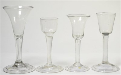 Lot 172 - A group of four 18th century English wine glasses, with various bowls on plain stems and folded...