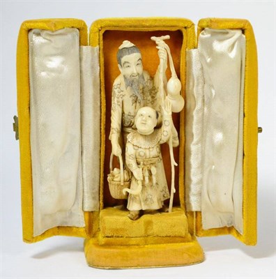 Lot 186 - A late 19th/early 20th century Chinese ivory group depicting two figures and bearded man...