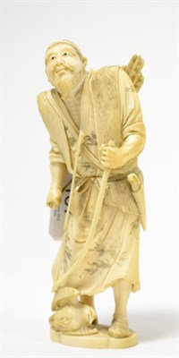 Lot 187 - A Japanese ivory okimono of a hunter, Meiji period, a bird at his feet, 16cm high
