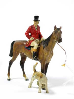 Lot 194 - A cold painted bronze huntsman with hound, 11cm high