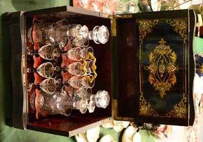 Lot 214 - A 19th century French brass and mother-of-pearl inlaid ebonised decanter box of serpentine form...