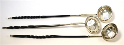 Lot 218 - ^Three toddy ladles, one set with a coin