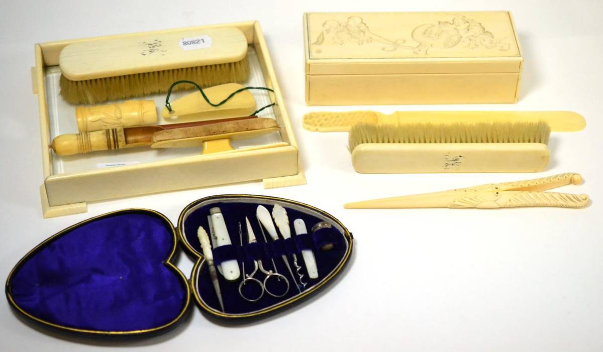 Lot 222 - A early 20th century Japanese ivory box, two brushes, glove stretchers, a page turner, a tray,...
