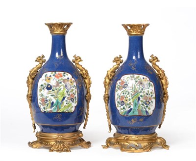Lot 238 - A pair of gilt metal mounted Sampson porcelain vases with dragon handles, decorated with...