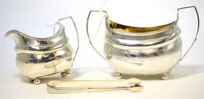 Lot 245 - ^A George II silver milk jug, matching sugar bowl and sugar nips, possibly R & S Hennell,...
