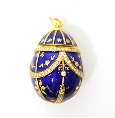 Lot 253 - A large diamond set enamelled egg charm, enamelled in blue with round brilliant cut diamond...