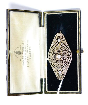 Lot 256 - A diamond set plaque brooch, three graduated old diamonds in white milled settings, within a...