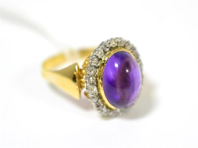 Lot 257 - An amethyst and diamond cluster ring, an oval cabochon amethyst within a border of single-cut...