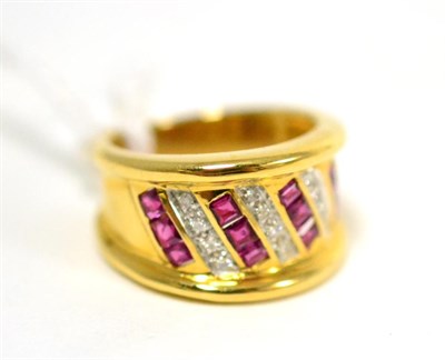 Lot 270 - A ruby and diamond ring, diagonally set with four columns of calibré cut rubies, in yellow channel